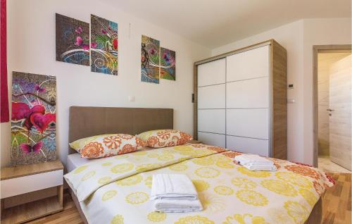 a bedroom with a bed with towels on it at Three-Bedroom Apartment In Medulin in Medulin