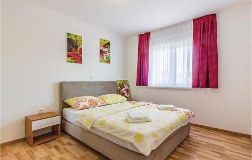 a bedroom with a bed and a window at Three-Bedroom Apartment In Medulin in Medulin
