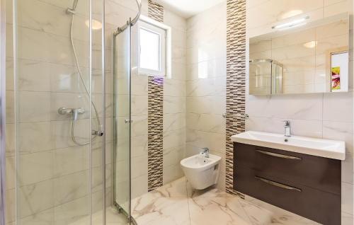 a bathroom with a shower and a sink and a toilet at Three-Bedroom Apartment In Medulin in Medulin