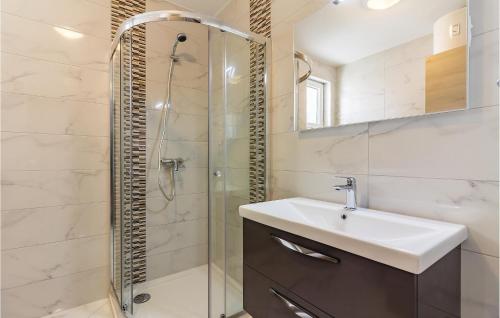 a bathroom with a sink and a shower at Three-Bedroom Apartment In Medulin in Medulin