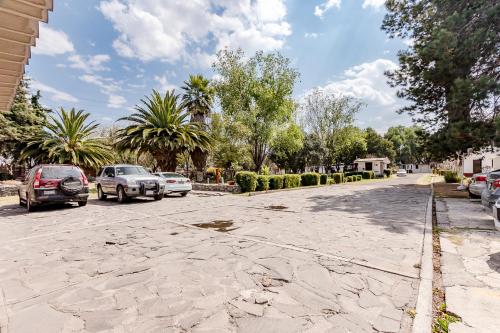a street with cars parked on the side of the road at Ayenda Mesón del Río in Tepotzotlán