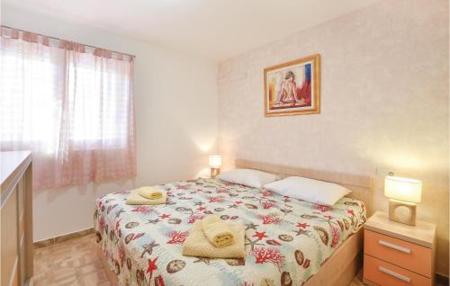 a bedroom with a bed with two towels on it at Beautiful Apartment In Stanici With 1 Bedrooms And Wifi in Čelina