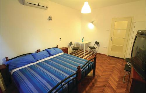 a bedroom with a bed and a table and a television at 1 Bedroom Awesome Apartment In Pula in Pula