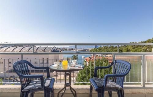 a table and chairs on a balcony with a view at Two-Bedroom Apartment In Ploce in Ploče