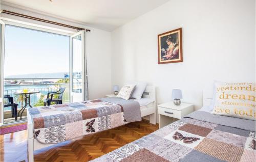 a bedroom with two beds and a balcony at Two-Bedroom Apartment In Ploce in Ploče