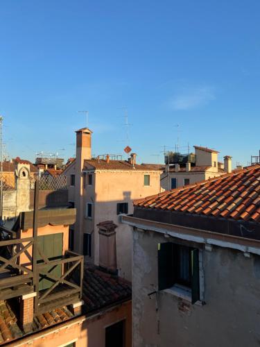 a view of roofs of buildings in a city at Alloggi Ai Tessitori in Venice