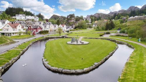 a small town with a river in the middle at Bergen/Sotra:Waterfront cabin(s).Boat.Fish.Jacuzzi in Haganes