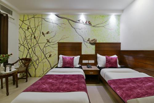 Postel nebo postele na pokoji v ubytování Hotel Yuvraj Deluxe
