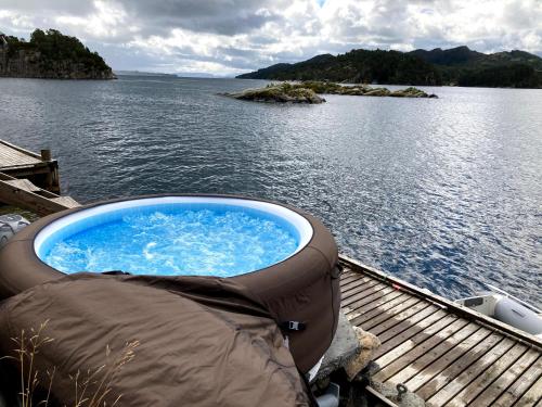 a hot tub sitting on the deck of a boat at Bergen/Sotra:Waterfront cabin(s).Boat.Fish.Jacuzzi in Haganes