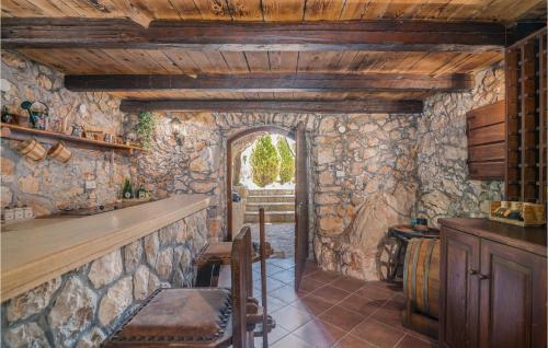 a room with a bar and a stone wall at 2 Bedroom Pet Friendly Home In Gostinjac in Gostinjac