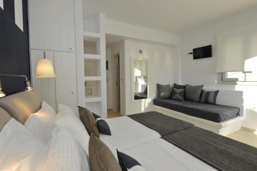 a living room with two beds and a couch at Romantica Suites in Naousa