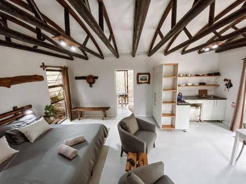 a bedroom with a bed and a couch and a table at Kleinrivier Mountain Escapes in Uitenhage