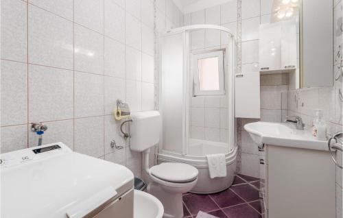a white bathroom with a toilet and a sink at Nice Apartment In Garica With Kitchen in Garica