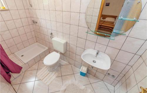 a white bathroom with a sink and a toilet at Lovely Apartment In Grizane With Wifi in Kostelj