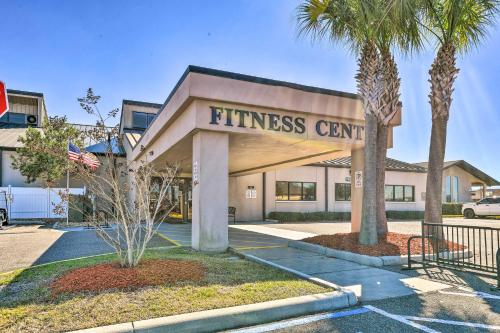 a fitness center with palm trees in front of it at Pool Access Ranch-Style House in Sun City Center in Sun City Center