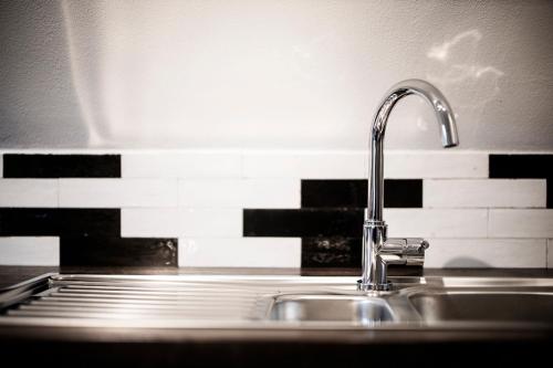 a kitchen sink with a faucet on a counter at Q-Stall am Poppenberg in Brilon