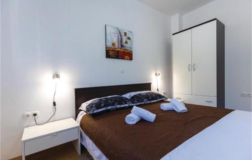 a bedroom with a large bed with two towels on it at Awesome Apartment In Klek With 1 Bedrooms And Wifi in Klek