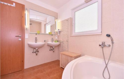 a bathroom with a sink and a tub and a sink at Awesome Apartment In Pisak With House Sea View in Pisak