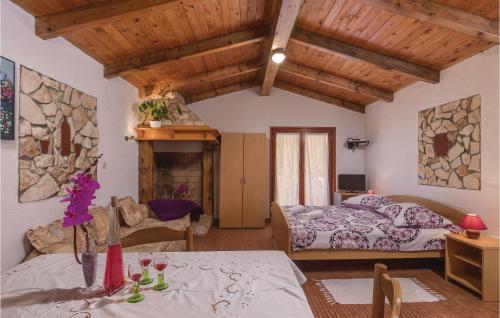 a bedroom with two beds and a stone wall at Gorgeous Home In Visnjan With Outdoor Swimming Pool in Višnjan