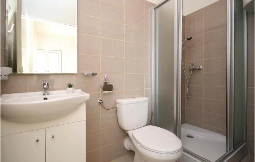a bathroom with a toilet and a sink and a shower at Stunning Apartment In Raslina With 1 Bedrooms And Wifi in Raslina