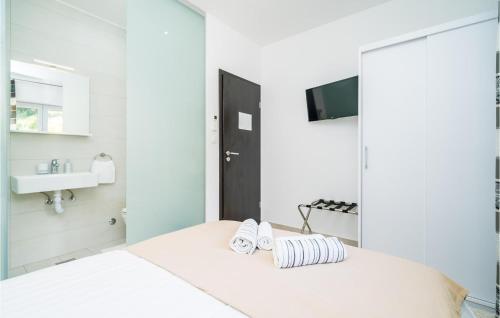 - une chambre blanche avec un lit et un lavabo dans l'établissement Pet Friendly Apartment In Cilipi With Wifi, à Čilipi