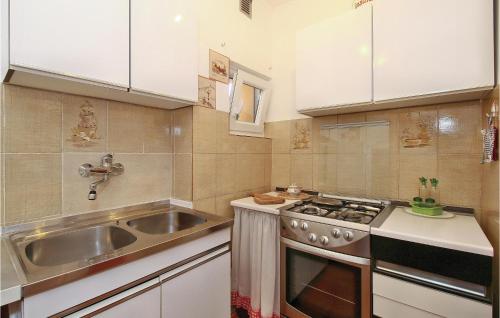 a kitchen with a sink and a stove at Awesome Apartment In Novigrad With Kitchen in Novigrad Istria