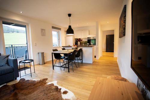 a kitchen and living room with a table and chairs at Q-Stall am Poppenberg in Brilon