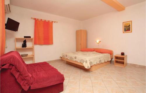 a small bedroom with a bed and a couch at Lovely Apartment In Vela Luka With Kitchen in Vela Luka