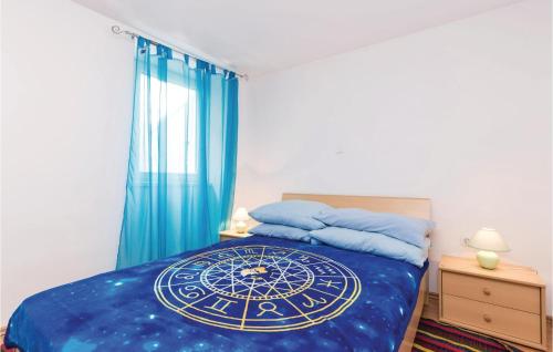 een slaapkamer met een bed met een blauw dekbed bij Beautiful Apartment In Senj With 1 Bedrooms And Wifi in Senj