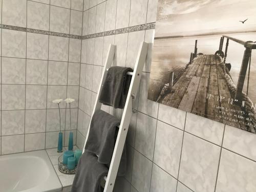 a bathroom with a picture of a pier on the wall at Ferienapartment Alma in Erfurt