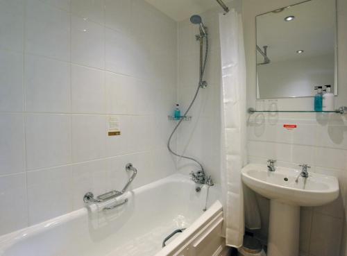 a bathroom with a shower, sink, and toilet at Royal Hotel by Greene King Inns in Ross on Wye