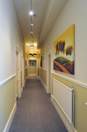 a hallway in a building with a painting on the wall at Royal Hotel by Greene King Inns in Ross on Wye