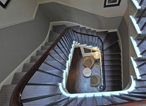 a spiral staircase in a home with blue stairs at Royal Hotel by Greene King Inns in Ross on Wye