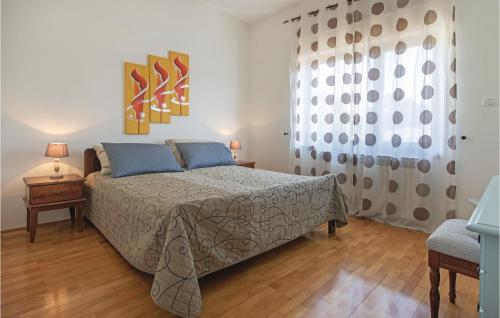 a bedroom with a bed with blue pillows at 4 Bedroom Gorgeous Apartment In Medulin in Medulin