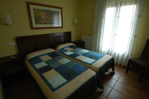 เตียงในห้องที่ Alojamiento Rural La Henera