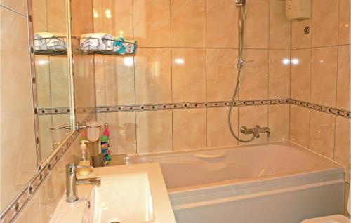 a bathroom with a tub and a toilet at 3 Bedroom Beautiful Apartment In Kastel Novi in Kastel Novi