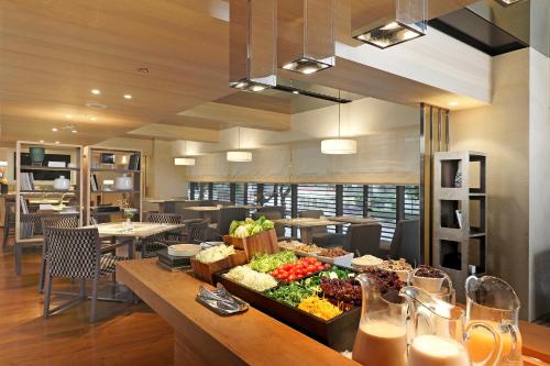 a restaurant with a buffet of food on a table at Hotel COZZI Minsheng Taipei in Taipei