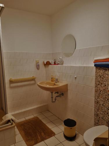 a bathroom with a sink and a toilet at Ferienwohnung Siebmann in Neuruppin