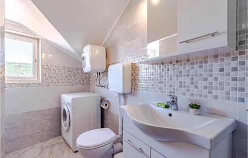 a white bathroom with a toilet and a sink at Nice Apartment In Vela Luka With 2 Bedrooms And Wifi in Vela Luka