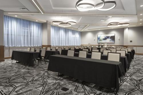 a conference room with rows of tables and chairs at Crowne Plaza Lansing by IHG in Lansing