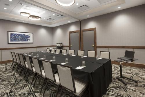 a conference room with a long table and chairs at Crowne Plaza Lansing by IHG in Lansing