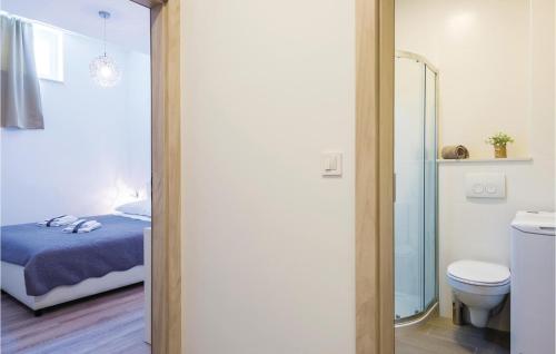 a bathroom with a bed and a toilet in a room at Beautiful Apartment In Cavtat With 1 Bedrooms And Wifi in Cavtat