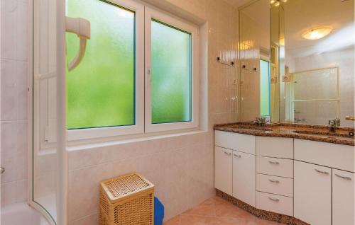 a bathroom with a sink and a shower and a mirror at Amazing Home In Kraljevica With 2 Bedrooms And Wifi in Kraljevica