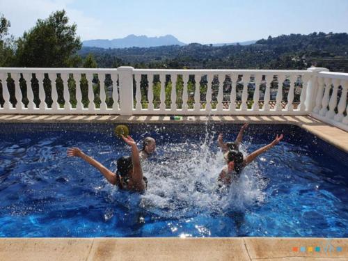 three people playing in a swimming pool at VH CostaBlanca - RULLE in Benissa