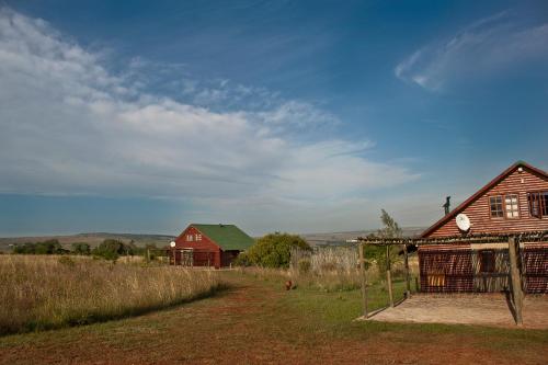 a farm with two barns and a red house at Stone Hill in Magaliesburg