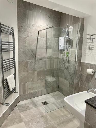 a bathroom with a shower and a sink at Dairy Guest House in York