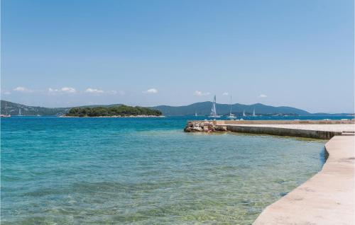 a view of a body of water with a pier at One-Bedroom Apartment In Jezera in Jezera
