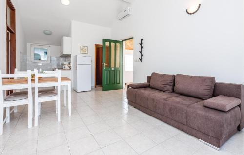 a living room with a couch and a table at One-Bedroom Apartment In Jezera in Jezera