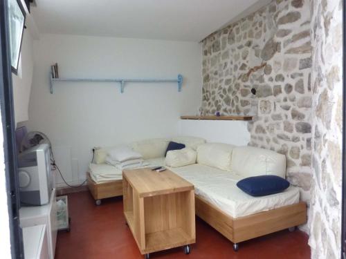 a living room with a couch and a table at Apartment Old Town Design in Rab