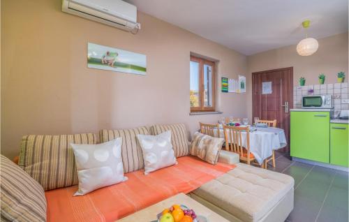 a living room with a couch and a table at 2 Bedroom Gorgeous Apartment In Njivice in Njivice